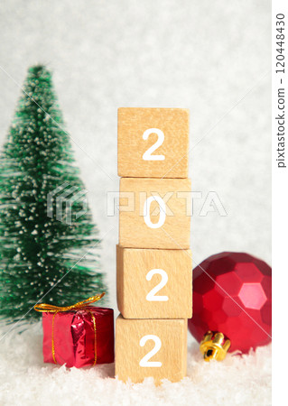 Christmas background with fir trees and Christmas decorations and numerals 2022. New Year concept on silver background. 120448430