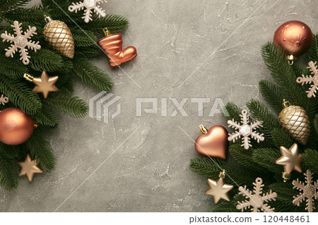 Christmas frame - tree branches gold baubles, stars, snowflakes on grey background. 120448461