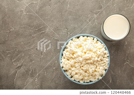 Cottage cheese and milk for breakfast in bowl on grey background. 120448466
