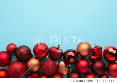 Red christmas baubles on blue background. New Year 120448537