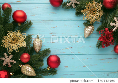 Red and gold Christmas toys decoration on blue background with copy space. New Year greeting card. Minimal style. Flat lay. 120448560