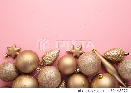 Gold Christmas toys decoration on pink background with copy space. New Year greeting card. Minimal style. Flat lay. Gold Christmas toys decoration on pink background with copy space. New Year greeting card. Minimal style. Flat lay. 120448572