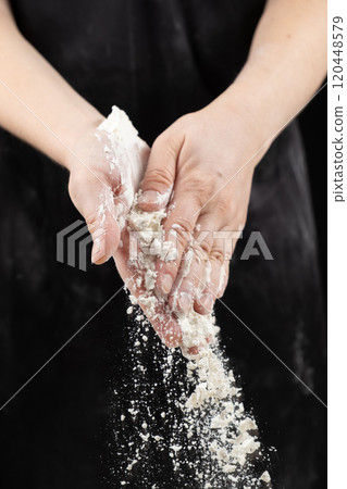The texture of white wheat flour, the flour spills out of the cooks hands. The texture of white wheat flour, the flour spills out of the cooks hands. 120448579