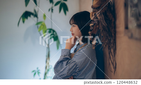 A young female cafe clerk thinking A young female cafe clerk thinking 120448632