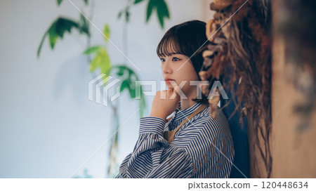 A young female cafe clerk thinking A young female cafe clerk thinking 120448634