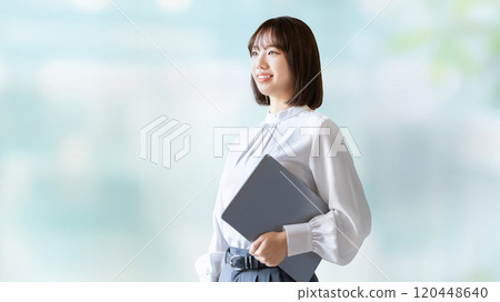 Smiling woman/businesswoman with a laptop Smiling woman/businesswoman with a laptop 120448640