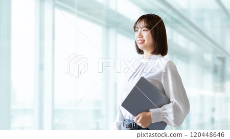 Smiling woman/businesswoman with a laptop Smiling woman/businesswoman with a laptop 120448646