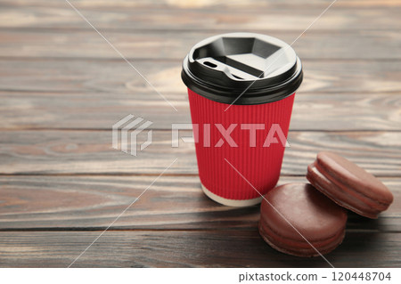 Choco pie chocolate coated snacks with cup of coffee on brown background. Choco pie chocolate coated snacks with cup of coffee on brown background. 120448704