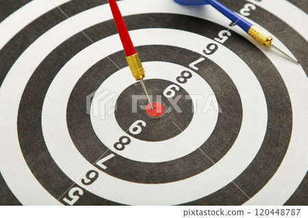 Close up shot red dart arrow on center of dartboard, metaphor to target success, winner concept. 120448787