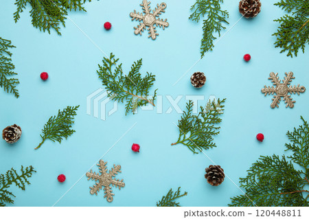 Thuja branch and christmas decoration on blue background. 120448811