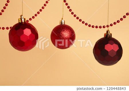 Red Christmas balls on beige background. New Year concept. 120448843
