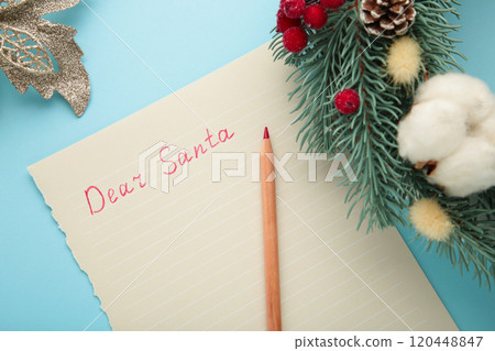 Letter to Santa Claus with Christmas wreath on blue background. Inscription Dear Santa Letter to Santa Claus with Christmas wreath on blue background. Inscription Dear Santa 120448847