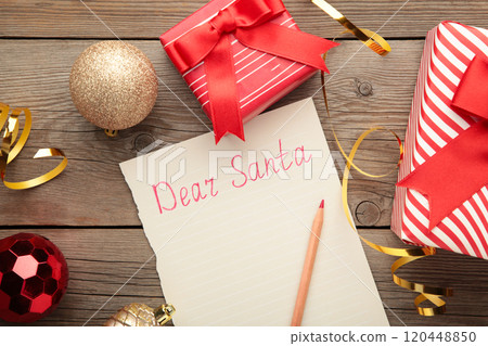 Letter to Santa Claus with Christmas decoration on grey wooden background. Inscription Dear Santa Letter to Santa Claus with Christmas decoration on grey wooden background. Inscription Dear Santa 120448850