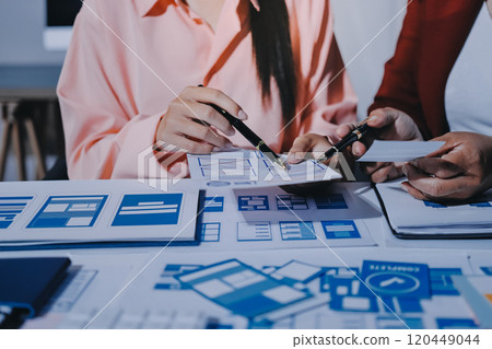 Young Asian business creative team work together, mobile application software design project. Brainstorm meeting, internet technology, smartphone web app designer, office coworker teamwork concept 120449044