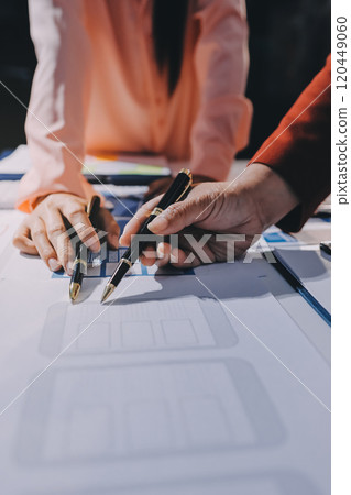 Young Asian business creative team work together, mobile application software design project. Brainstorm meeting, internet technology, smartphone web app designer, office coworker teamwork concept Young Asian business creative team work together, mobile application software design project. Brainstorm meeting, internet technology, smartphone web app designer, office coworker teamwork concept 120449060