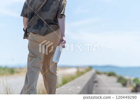 Person holding a bottle of water Person holding a bottle of water 120449290