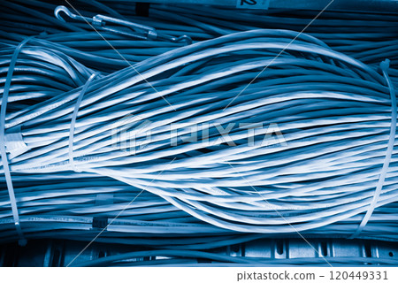 bunch of network cables in wave pattern leading across server ro bunch of network cables in wave pattern leading across server ro 120449331