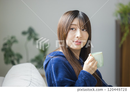 Young woman relaxing in a room 120449728