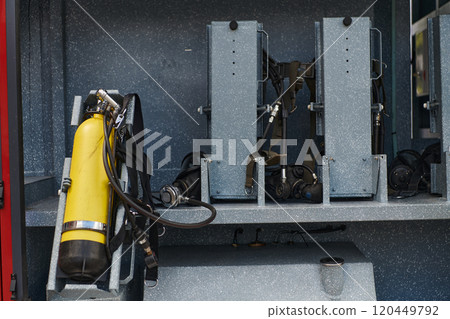 Close-up of essential firefighting equipment on a modern firetruck, showcasing tools and gear ready for emergency response to hazardous fire situations Close-up of essential firefighting equipment on a modern firetruck, showcasing tools and gear ready for emergency response to hazardous fire situations 120449792