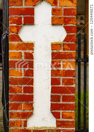 cross on brick wall of the old church cross on brick wall of the old church 120449871
