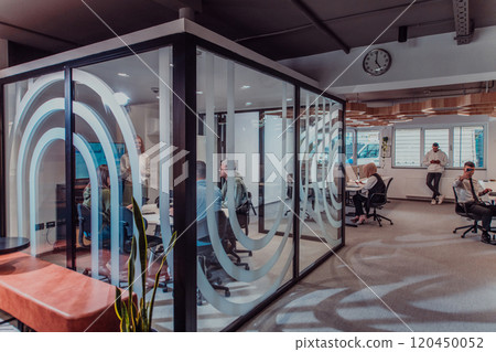 A group of young business entrepreneurs engages in a focused meeting, discussing various business strategies and collaboratively solving challenging problems, showcasing ambition, creativity, and 120450052