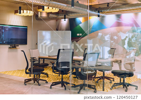 In the contemporary setting of an empty modern glass startup office, the space exudes a sleek and innovative atmosphere, ready to be filled with the potential of entrepreneurial endeavors 120450127