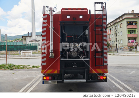 A state-of-the-art firetruck, equipped with advanced rescue technology, stands ready with its skilled firefighting team, prepared to intervene and respond rapidly to emergencies, ensuring the safety 120450212