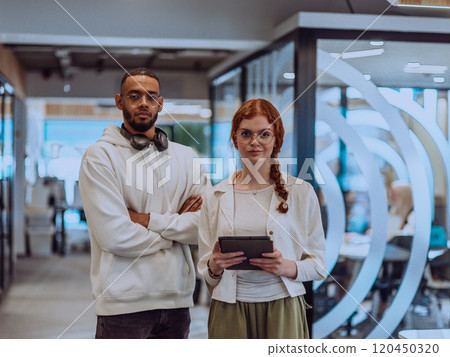 In a modern office African American young businessman and his businesswoman colleague, with her striking orange hair, engage in collaborative problem-solving sessions In a modern office African American young businessman and his businesswoman colleague, with her striking orange hair, engage in collaborative problem-solving sessions 120450320