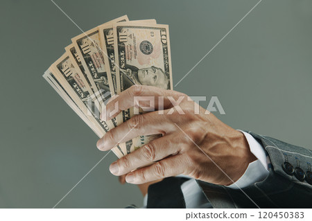 businessman has some dollars in his hands 120450383