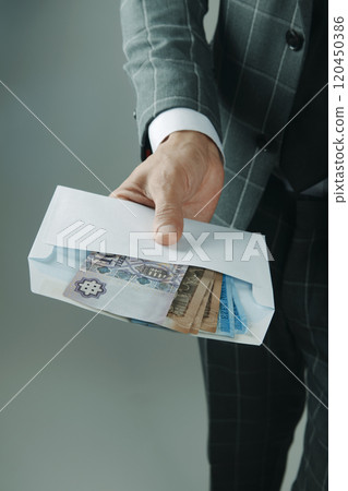 businessman offers an envelope with forints 120450386