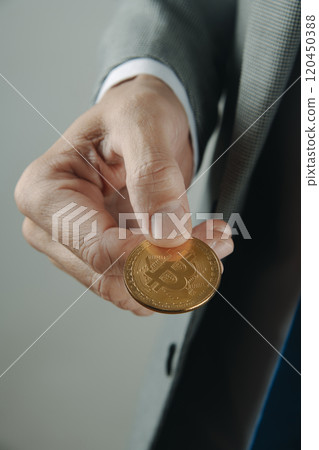 businessman holding a bitcoin in his hands 120450388
