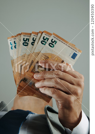 businessman with some euros seen from below businessman with some euros seen from below 120450390