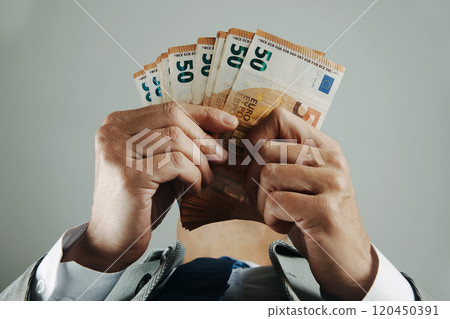 businessman counts some euro banknotes 120450391