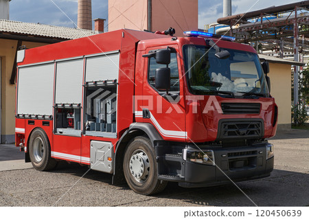 A state-of-the-art firetruck, equipped with advanced rescue technology, stands ready with its skilled firefighting team, prepared to intervene and respond rapidly to emergencies, ensuring the safety A state-of-the-art firetruck, equipped with advanced rescue technology, stands ready with its skilled firefighting team, prepared to intervene and respond rapidly to emergencies, ensuring the safety 120450639