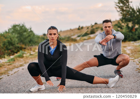 Romantic Couple Stretching Together After an Intense Morning Run Romantic Couple Stretching Together After an Intense Morning Run 120450829