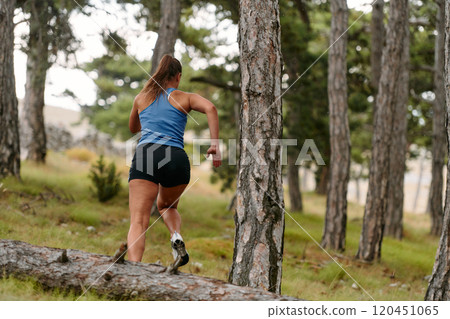Fearless Woman Conquering Wooden Obstacles in the Dangerous Forest Terrain. Fearless Woman Conquering Wooden Obstacles in the Dangerous Forest Terrain. 120451065