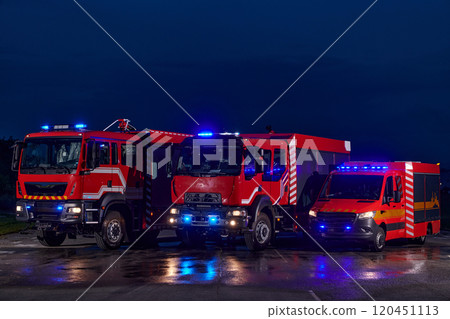A pair of highly modern and quality fire trucks illuminate the night with their rotating lights, symbolizing the cutting-edge technology and preparedness of the firefighting fleet, ready to respond to A pair of highly modern and quality fire trucks illuminate the night with their rotating lights, symbolizing the cutting-edge technology and preparedness of the firefighting fleet, ready to respond to 120451113