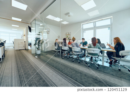 Diverse Business Team Discussing Projects in a Modern Glass Office. 120451129
