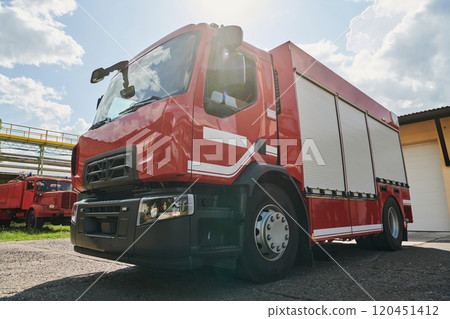 A state-of-the-art firetruck, equipped with advanced rescue technology, stands ready with its skilled firefighting team, prepared to intervene and respond rapidly to emergencies, ensuring the safety A state-of-the-art firetruck, equipped with advanced rescue technology, stands ready with its skilled firefighting team, prepared to intervene and respond rapidly to emergencies, ensuring the safety 120451412