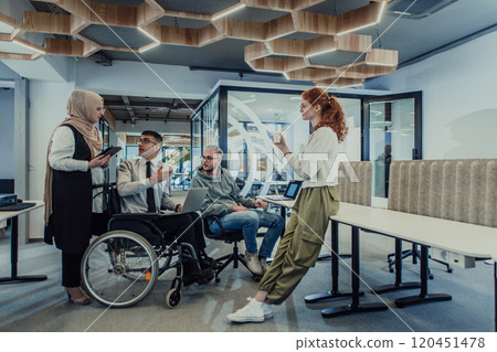 Young group of business people brainstorming together in a startup space, discussing business projects, investments, and solving challenges. 120451478