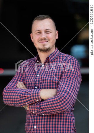 A successful young businessman in a shirt with crossed arms 120451653