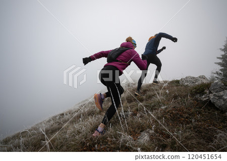 trail running couple man and woman running on a mountain path trail running couple man and woman running on a mountain path 120451654