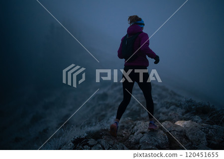 Exercising outdoors is healthy for active lifestyle runners. Autumn trail run woman running in nature from behind in dark forest. Outdoor jog. Exercising outdoors is healthy for active lifestyle runners. Autumn trail run woman running in nature from behind in dark forest. Outdoor jog. 120451655