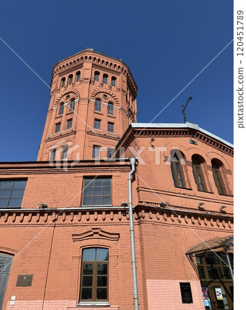 Historic Red Brick Water Tower Against Clear Blue Sky Historic Red Brick Water Tower Against Clear Blue Sky 120451789