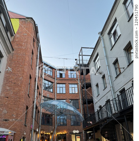 Cozy Urban Courtyard with Red Brick Walls and Umbrella Decoration Cozy Urban Courtyard with Red Brick Walls and Umbrella Decoration 120451790