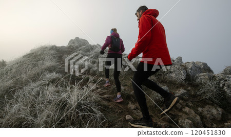trail running couple man and woman running on a mountain path trail running couple man and woman running on a mountain path 120451830