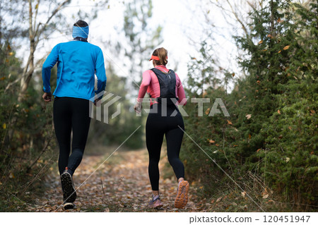 trail running with a sporty couple in the magic forest in early morning trail running with a sporty couple in the magic forest in early morning 120451947
