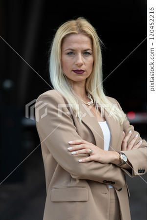 A powerful portrait of a businesswoman, standing confidently with her arms crossed A powerful portrait of a businesswoman, standing confidently with her arms crossed 120452216