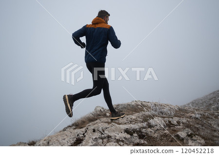 trail running man athlete prepares for ultra-marathon race in a mountain trail running man athlete prepares for ultra-marathon race in a mountain 120452218