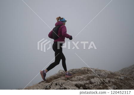 sky running or trail running woman exercising on a mountain top sky running or trail running woman exercising on a mountain top 120452317